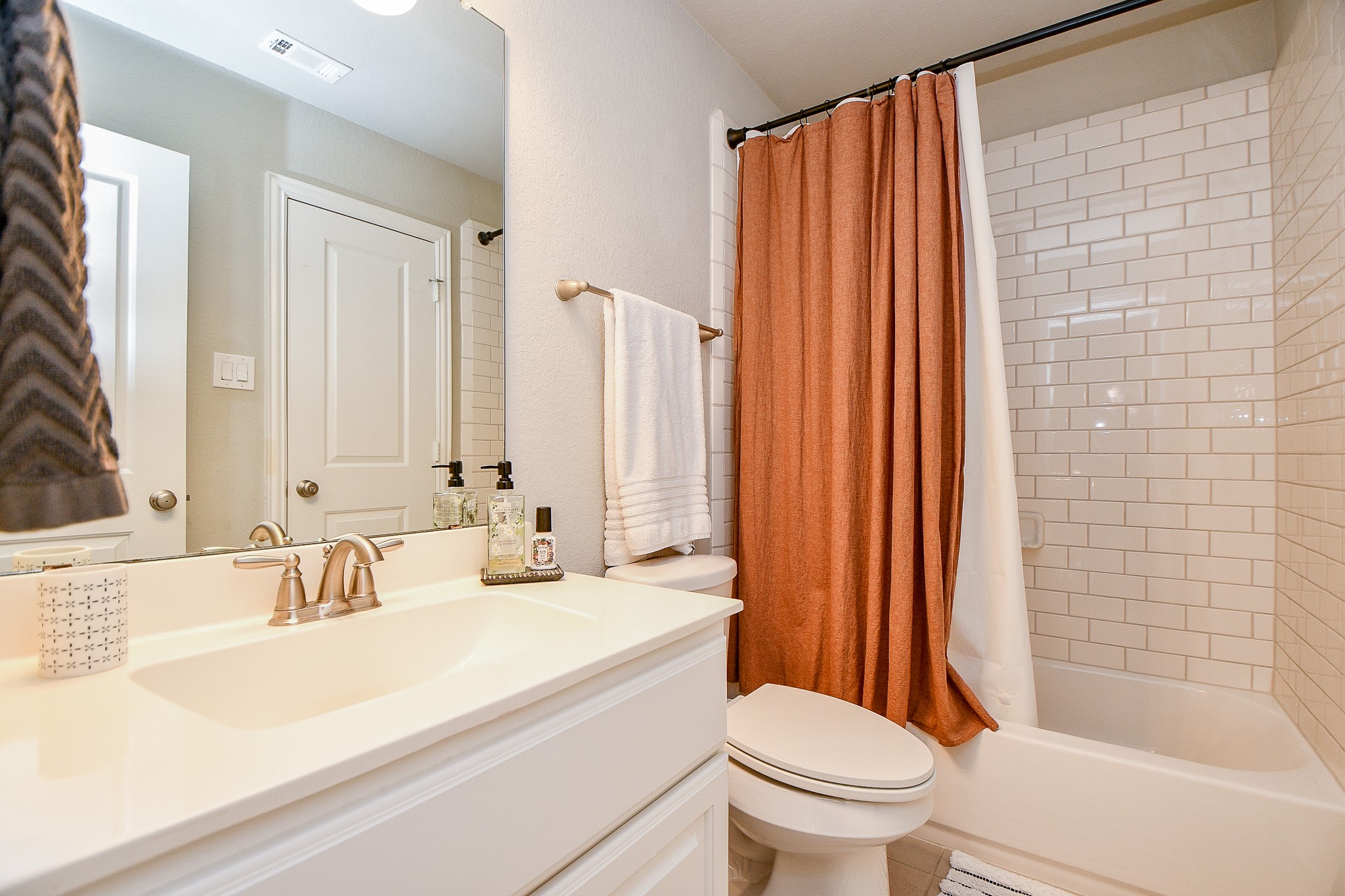 4523 Juniper Ridge Lane Manvel, TX 77578 - Photo 27 of 38 a bathroom with a sink a toilet and shower curtain
