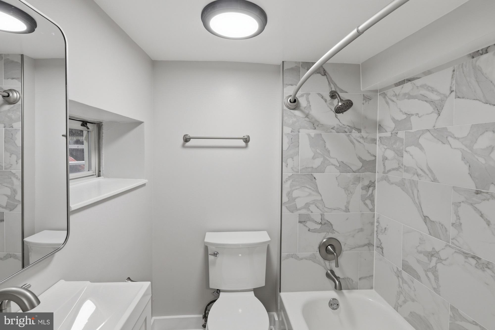 2388 Champlain Street Northwest, Unit 2 Washington, DC 20009 - Photo 10 of 13 a bathroom with a toilet sink and shower