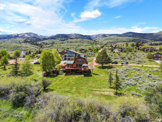 371 Lewis Loop, Unit 29 Fish Haven, ID 83287 - Photo 11 of 40 Terraced property featuring a multi-level deck with a built-in gazebo, expansive grassy areas, and mature trees