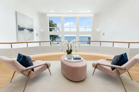 a bedroom with a large bed and a large window