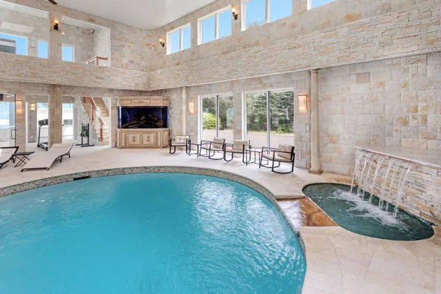 a view of a swimming pool with outdoor seating