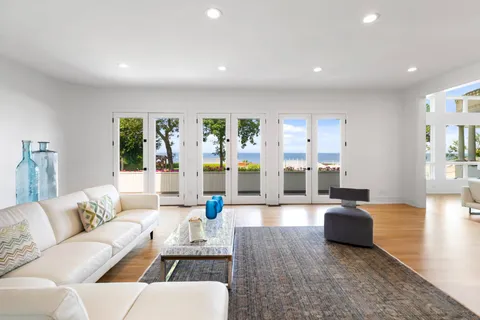 a living room with furniture and large windows