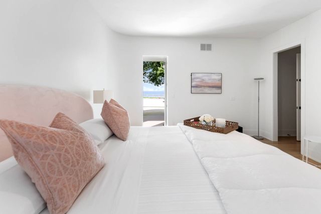 a bedroom with furniture and painting on the wall