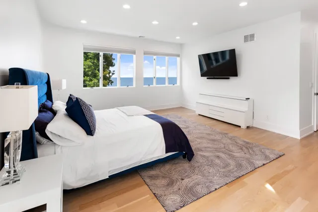 a large white bed in a white room
