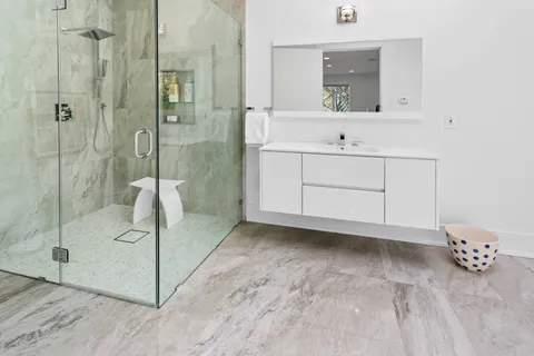 a bathroom with a sink a mirror and shower