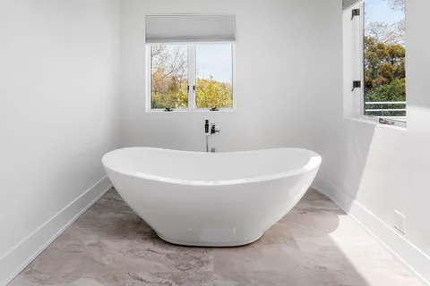 a white bath tub sitting in a bathroom