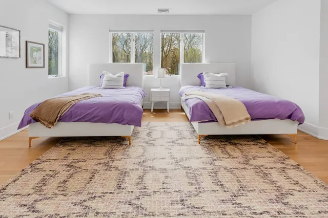 a bedroom with two beds and a window