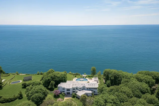 a view of a lake with table and chairs