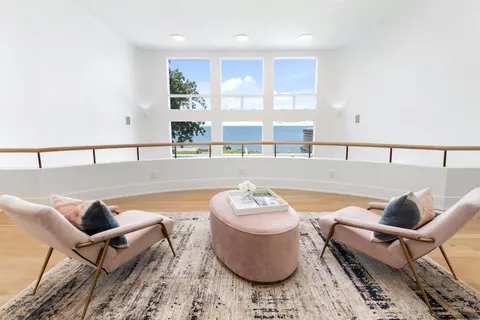 a outdoor dining space with lounge chair