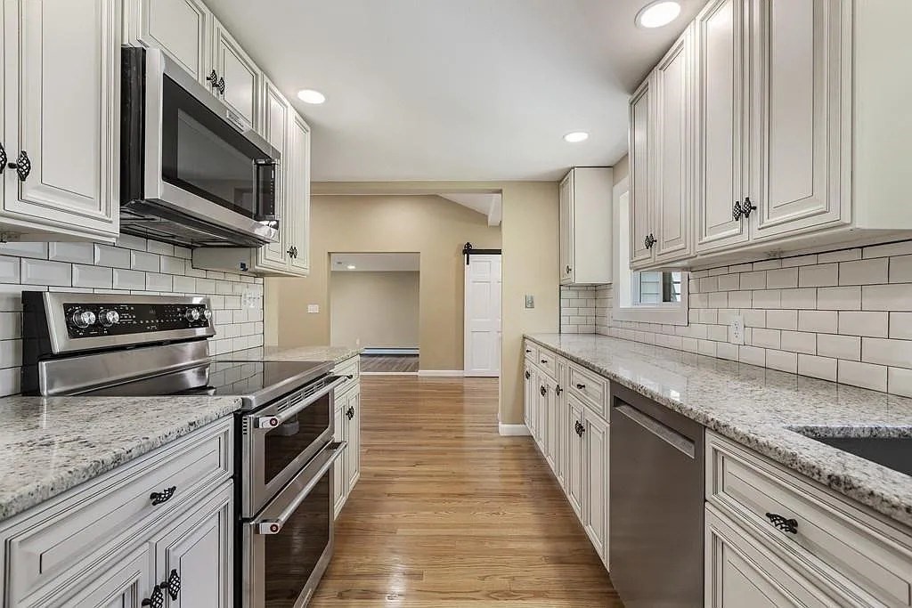 a kitchen with stainless steel appliances granite countertop a sink a stove oven and a granite counter tops