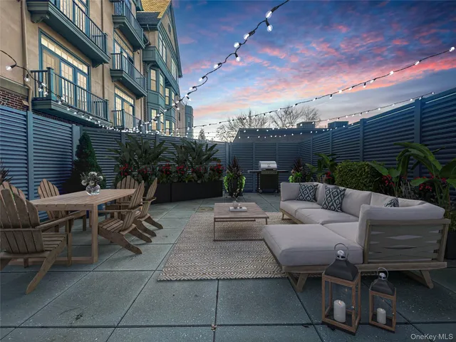 a view of a patio with couches and potted plants