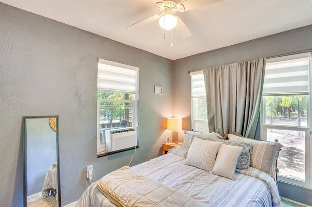 a bedroom with bed and a window