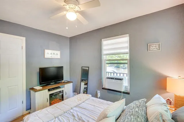 a bedroom with a bed and a flat screen tv