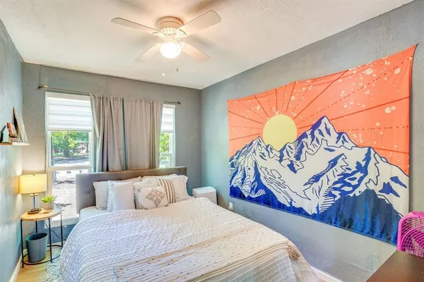 a bedroom with a bed and a window