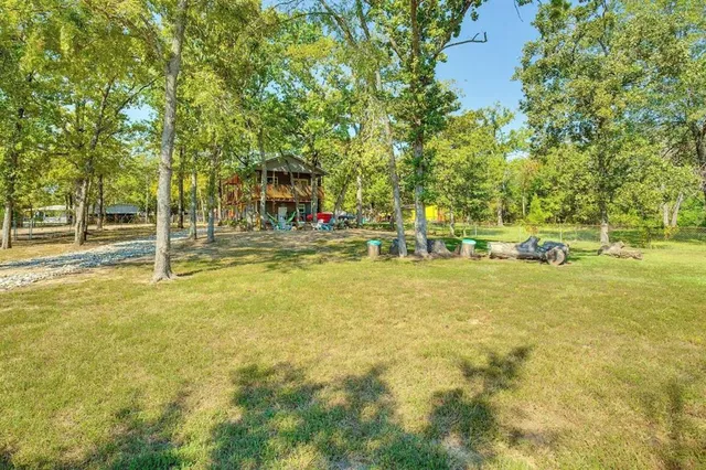 a view of yard with swimming pool and trees