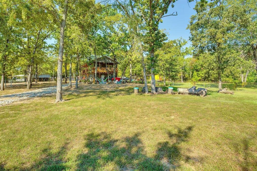 7110 Apache Circle Mabank, TX 75156 - Photo 30 of 36 a view of yard with swimming pool and trees
