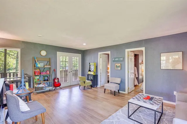 a living room with furniture and a wooden floor