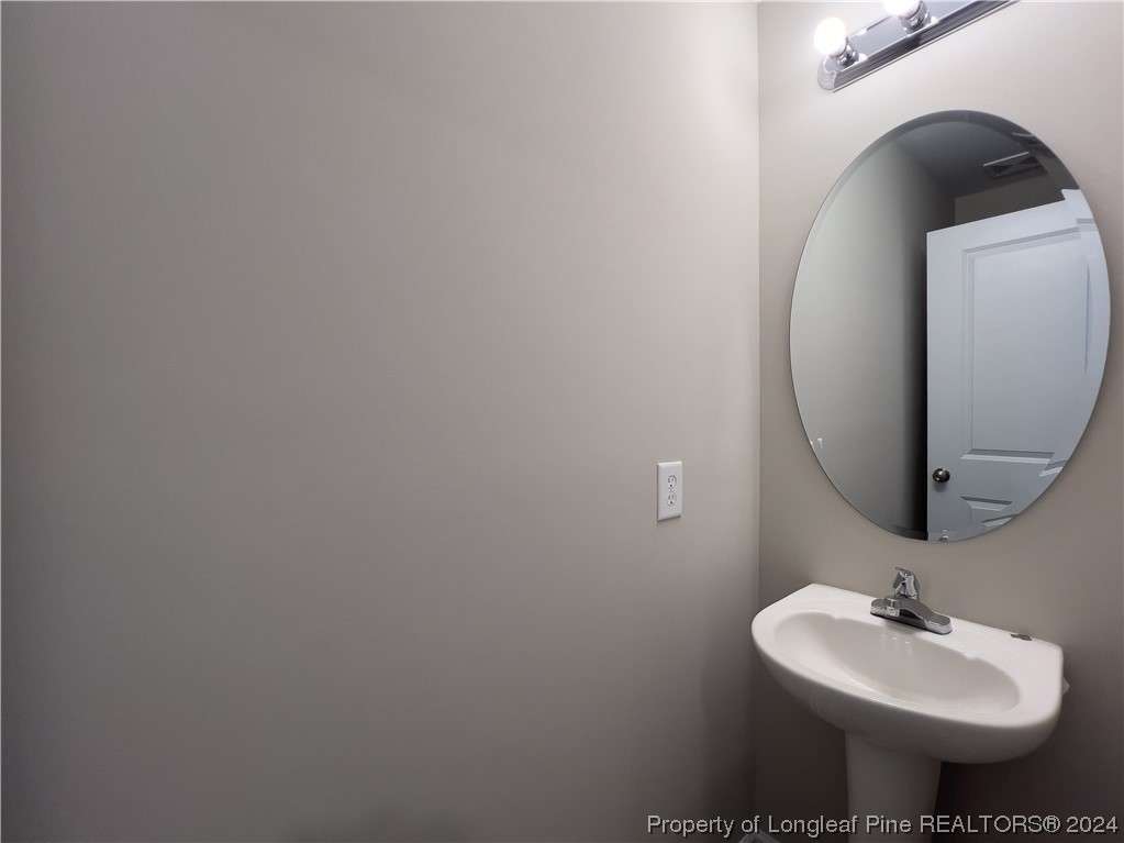 30 Pointer (lot 2) Way Parkton, NC 28371 - Photo 12 of 26 a bathroom with a sink and a mirror