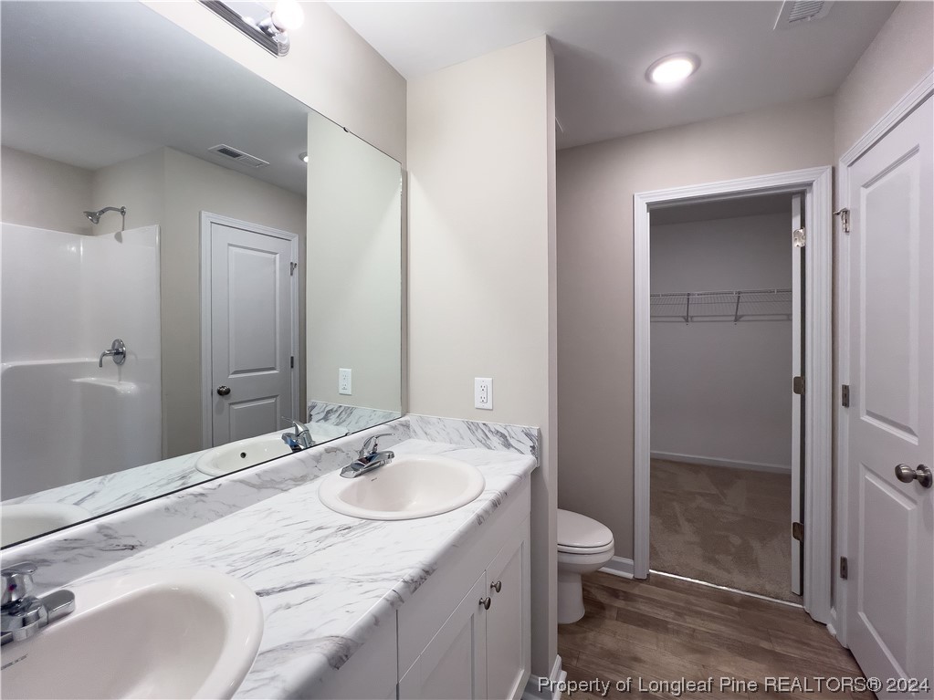 30 Pointer (lot 2) Way Parkton, NC 28371 - Photo 14 of 26 a bathroom with a granite countertop sink toilet and shower