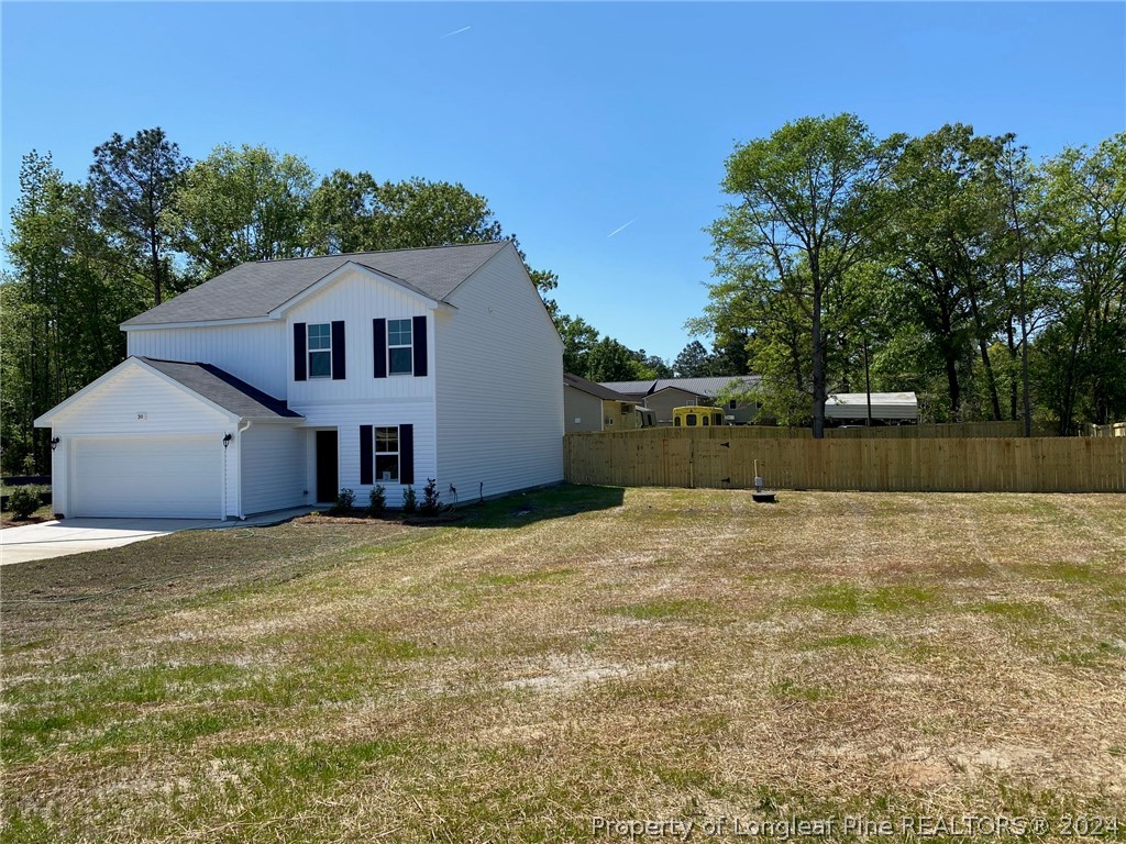 30 Pointer (lot 2) Way Parkton, NC 28371 - Photo 22 of 26 a front view of a house with a yard
