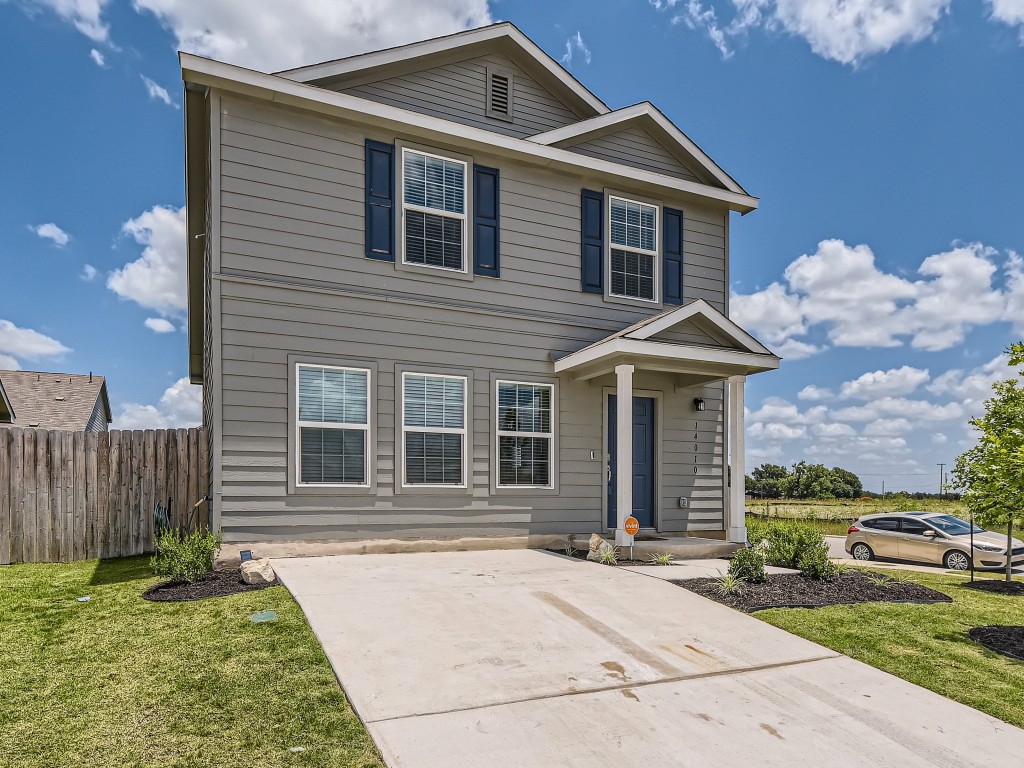 a front view of a house with garden
