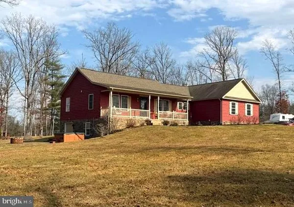 a front view of a house with a yard covered in snow
