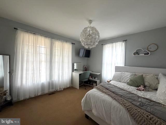 1156 Providence Church Road Hedgesville, WV 25427 - Photo 48 of 101 a bedroom with a bed and a chandelier
