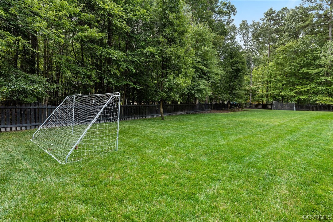 2921 Barrow Place Midlothian, VA 23113 - Photo 40 of 41 a view of a backyard with a wooden fence