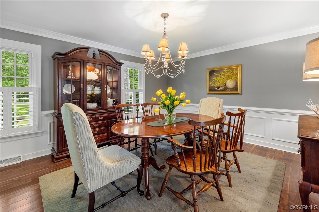2921 Barrow Place Midlothian, VA 23113 - Photo 6 of 41 a dining room with furniture a chandelier and wooden floor