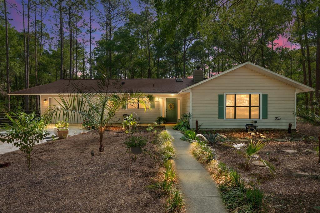 a backyard of a house with yard and outdoor seating