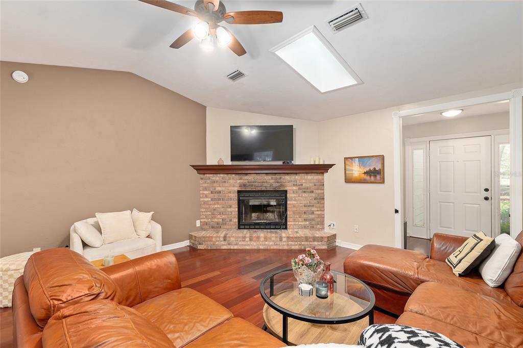 9917 Southwest 77 Court Gainesville, FL 32608 - Photo 12 of 28 a living room with furniture fireplace and a flat screen tv