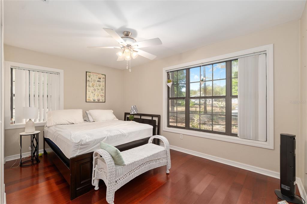 9917 Southwest 77 Court Gainesville, FL 32608 - Photo 20 of 28 a bedroom with a bed and a chandelier