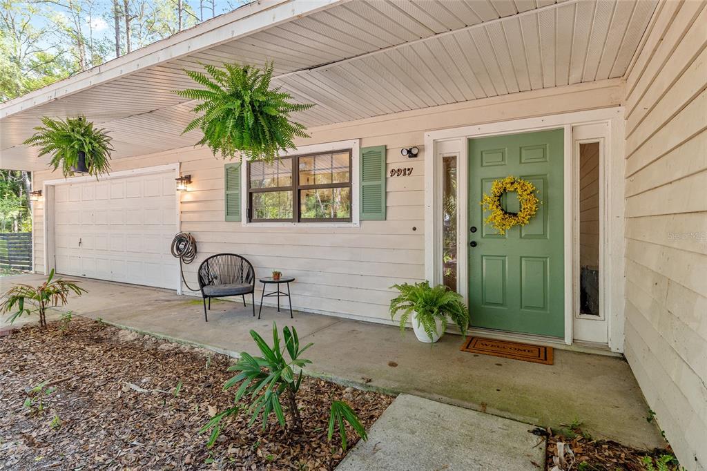9917 Southwest 77 Court Gainesville, FL 32608 - Photo 2 of 28 a front view of a house with garden