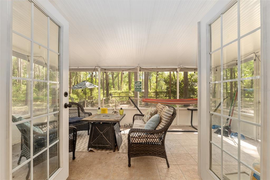 9917 Southwest 77 Court Gainesville, FL 32608 - Photo 23 of 28 a dining room with furniture and a floor to ceiling window