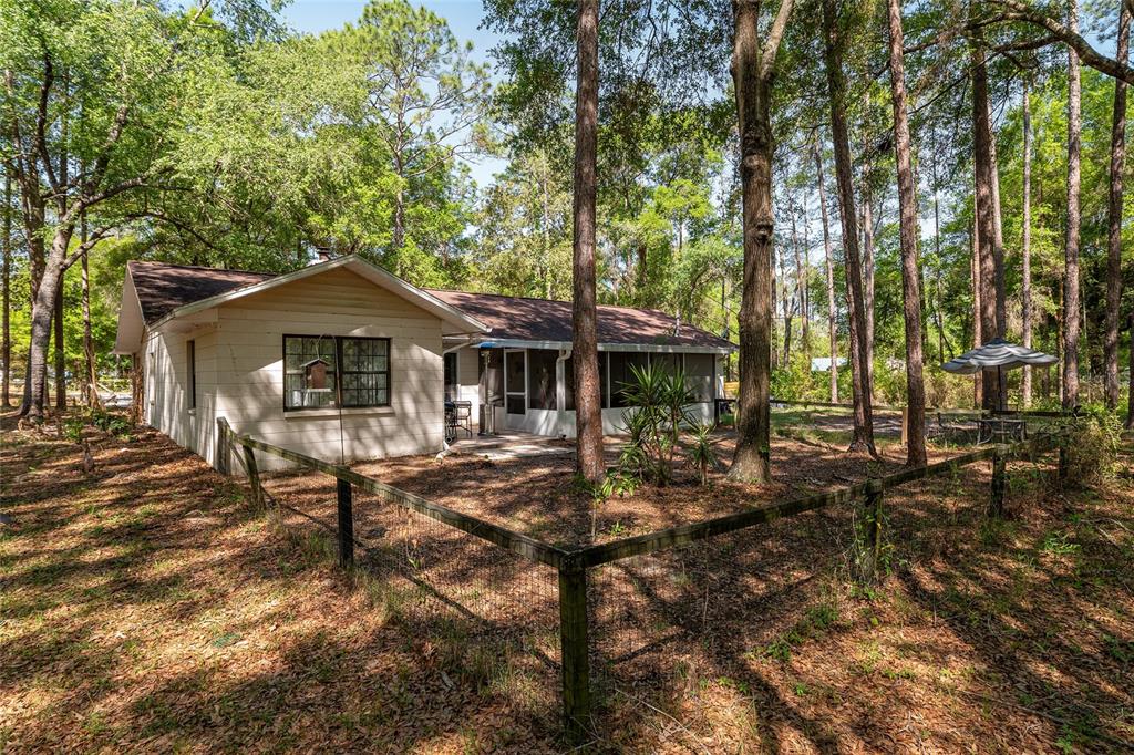 9917 Southwest 77 Court Gainesville, FL 32608 - Photo 25 of 28 a view of a house with backyard and sitting area