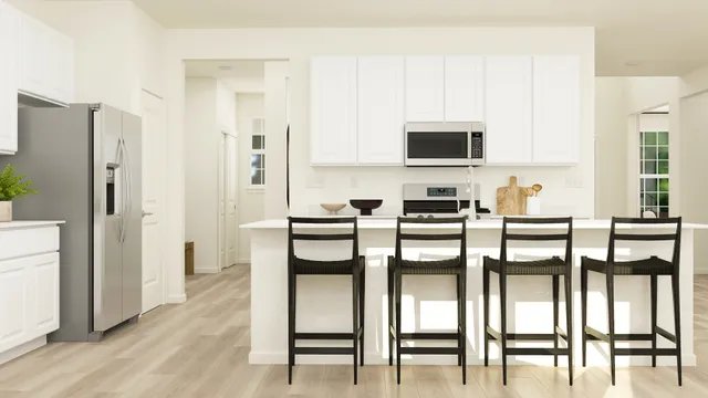 a kitchen with stainless steel appliances a stove a sink refrigerator and white cabinets with wooden floor