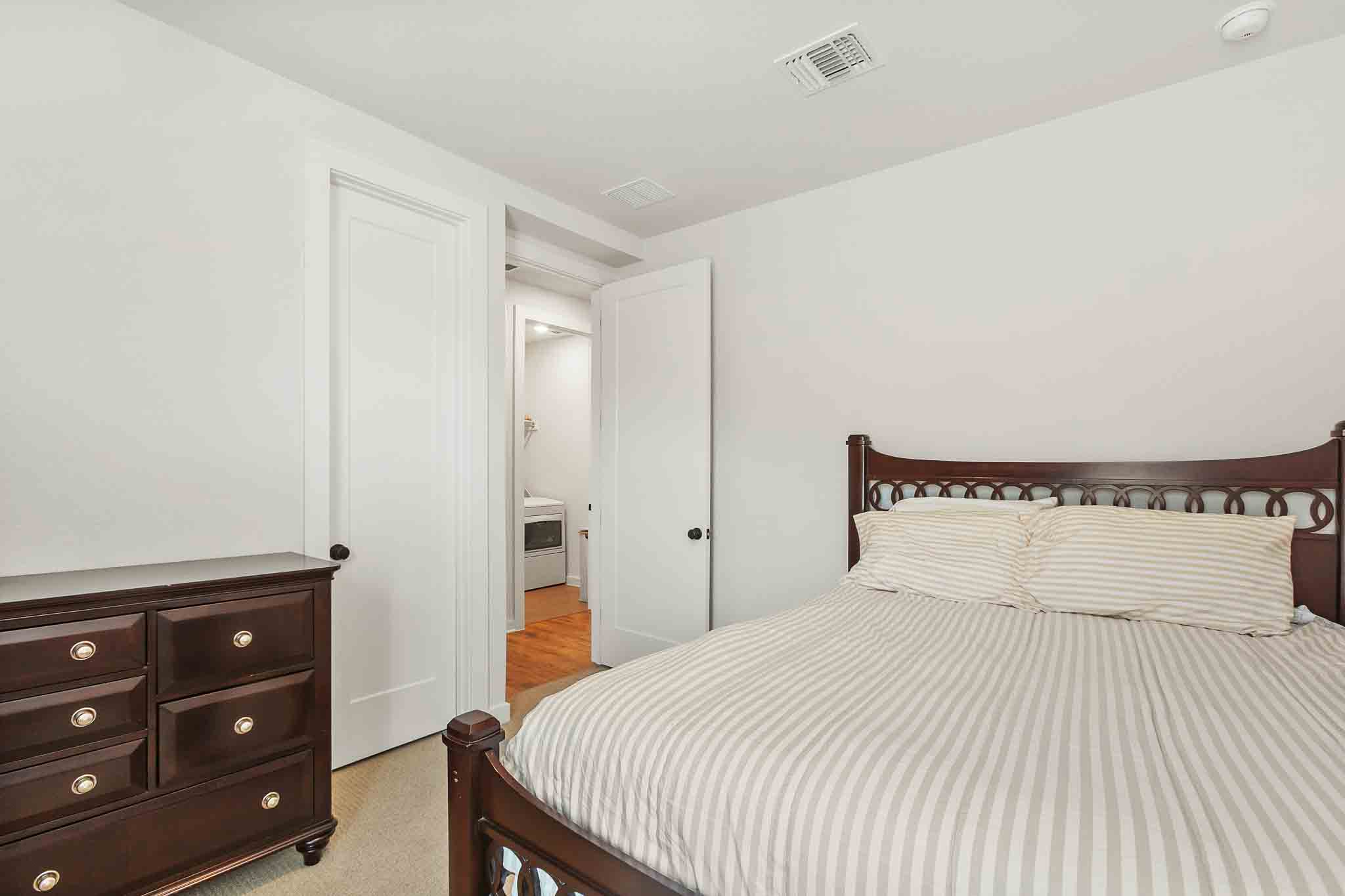 220 Basket Flower Loop Kyle, TX 78640 - Photo 31 of 40 A well-lit bedroom features plush carpeting and convenient access to the laundry area.