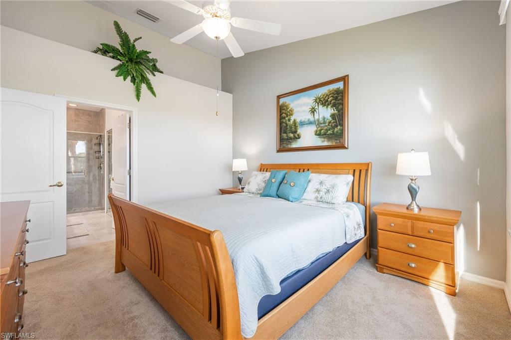 9209 Spring Run Boulevard, Unit 2003 Estero, FL 34135 - Photo 13 of 32 a bedroom with bed and a potted plant