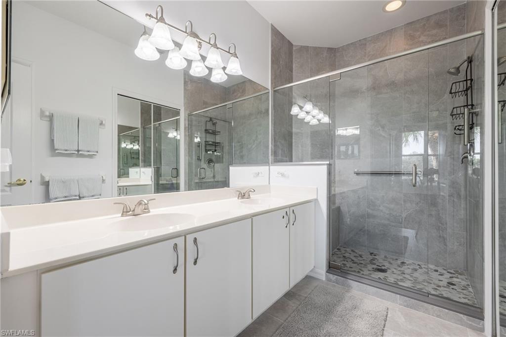 9209 Spring Run Boulevard, Unit 2003 Estero, FL 34135 - Photo 14 of 32 a bathroom with a sink shower and a mirror