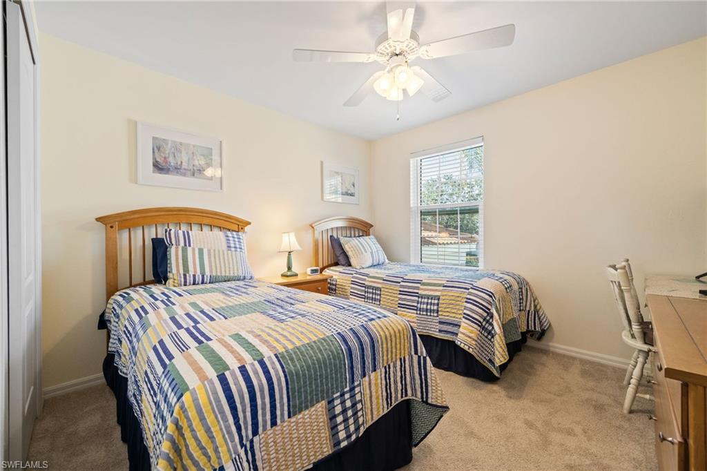 9209 Spring Run Boulevard, Unit 2003 Estero, FL 34135 - Photo 15 of 32 a bedroom with bed and a chandelier