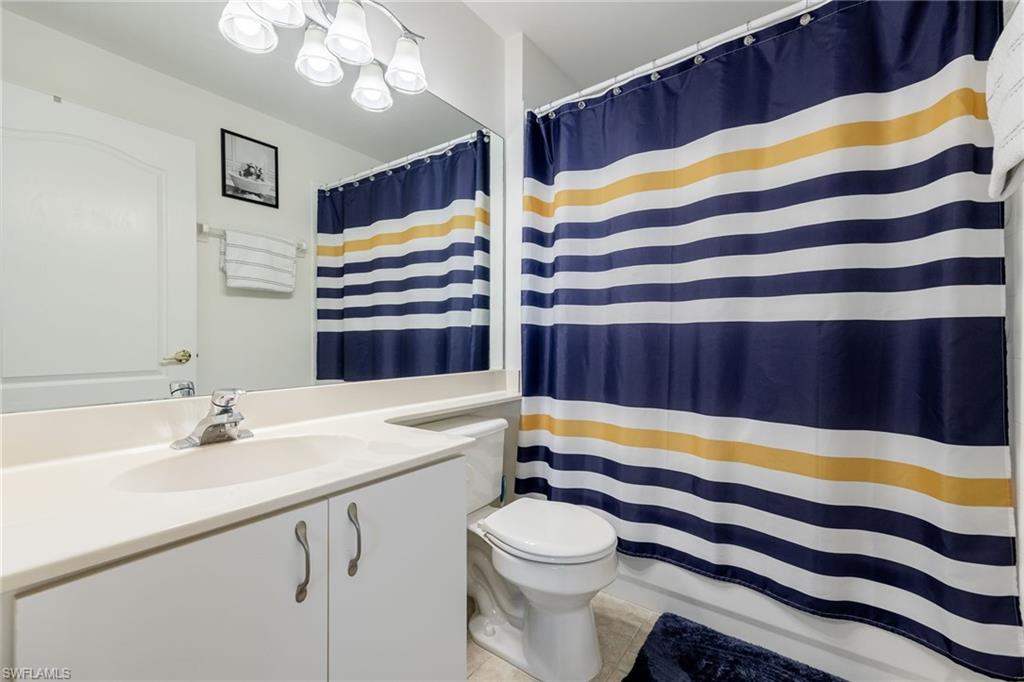 9209 Spring Run Boulevard, Unit 2003 Estero, FL 34135 - Photo 16 of 32 a bathroom with a sink a bathtub and a shower