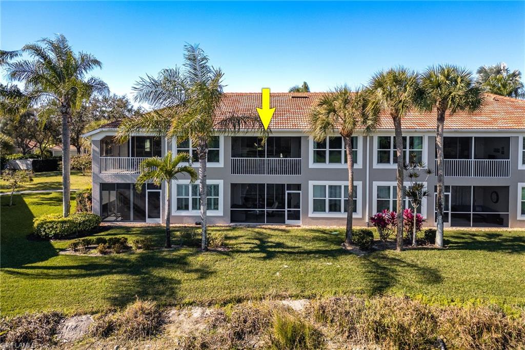 9209 Spring Run Boulevard, Unit 2003 Estero, FL 34135 - Photo 24 of 32 a front view of house with yard and swimming pool