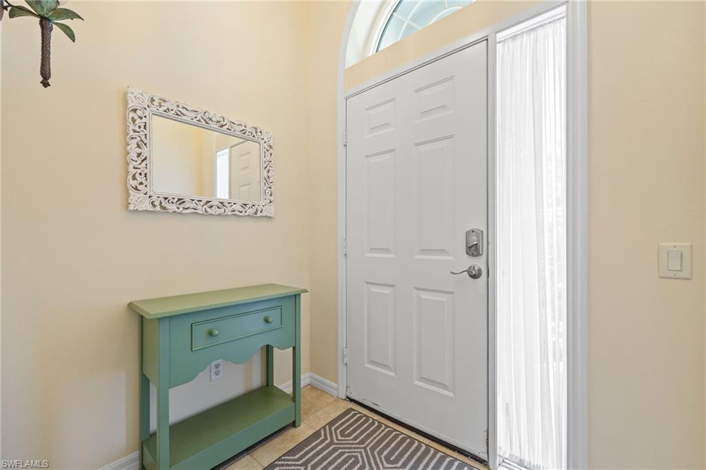 9209 Spring Run Boulevard, Unit 2003 Estero, FL 34135 - Photo 3 of 32 a hallway with a door and a mirror