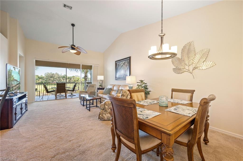 9209 Spring Run Boulevard, Unit 2003 Estero, FL 34135 - Photo 9 of 32 a dining room with furniture a chandelier and window