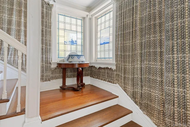 a bedroom with a bed wooden floor and window