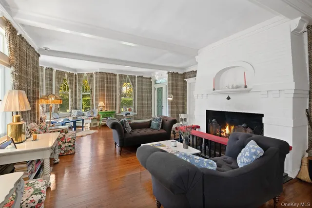 a living room with furniture fireplace and a large window