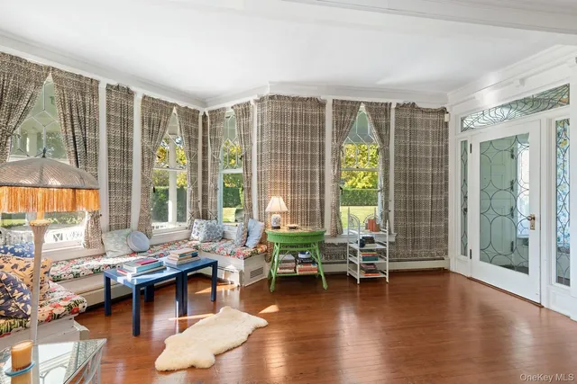 a living room with furniture and a large window with outer view