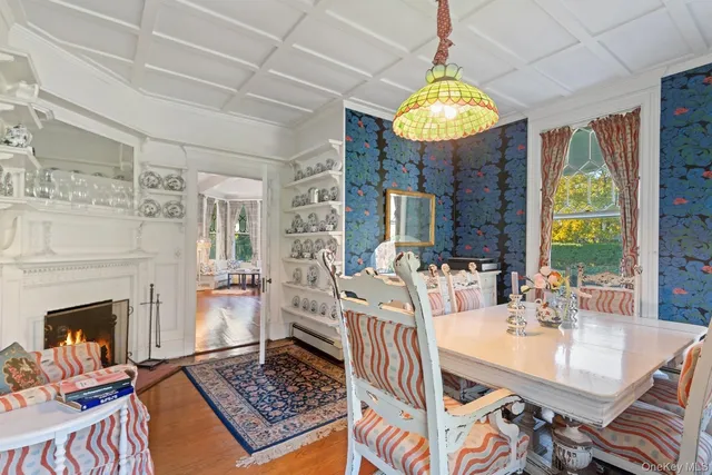 a living room with dining table and a fireplace