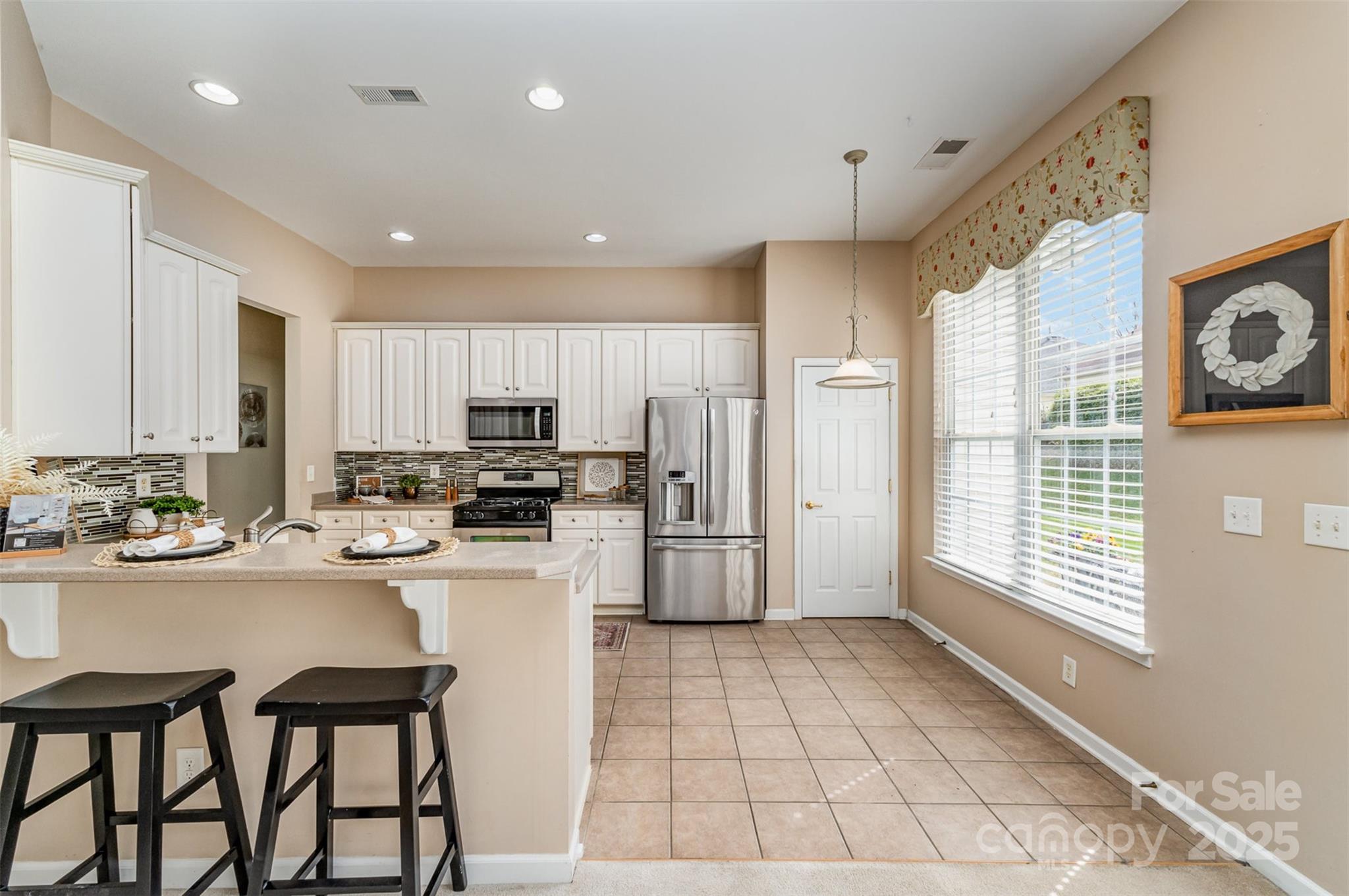 418 Garnet Court Fort Mill, SC 29708 - Photo 12 of 29 a kitchen with a refrigerator a stove and a cabinets