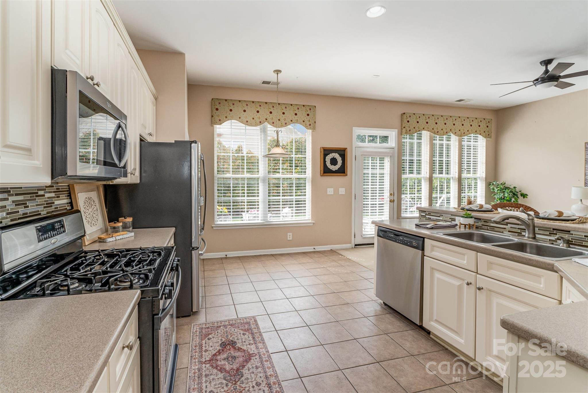 418 Garnet Court Fort Mill, SC 29708 - Photo 13 of 29 a kitchen with stainless steel appliances granite countertop a stove a sink and a refrigerator